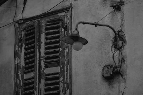 Black and white photo of an old building with shutters