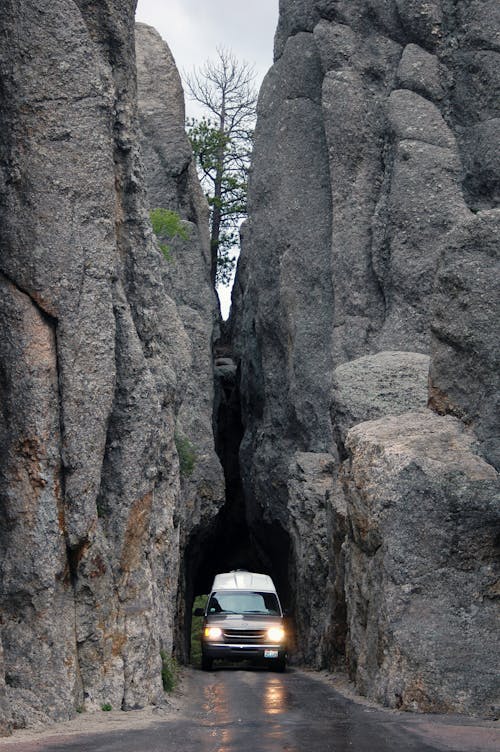 A van drives through a narrow tunnel