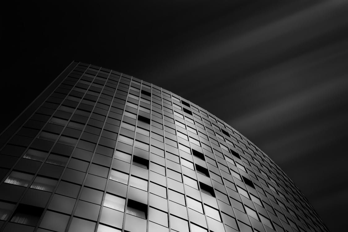 Low-angle Grayscale Photography of Curtain-wall Building