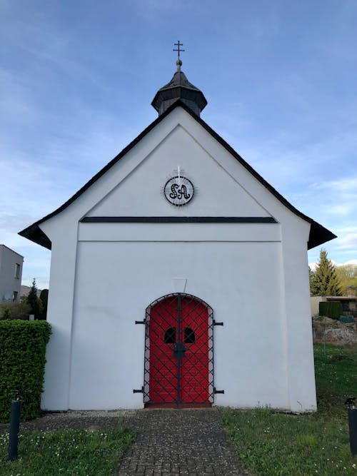 A small white church with a red door