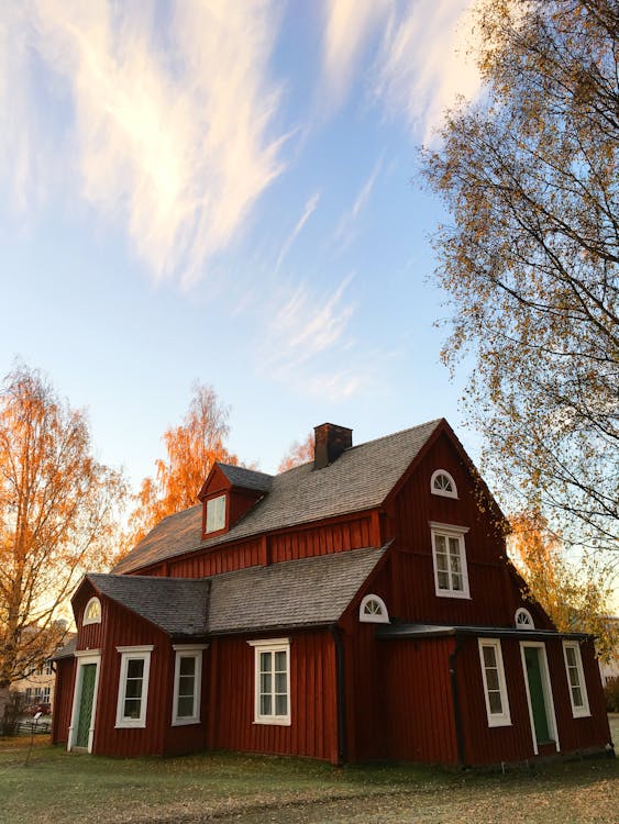 Red and Black Wooden House Under Blue Sky