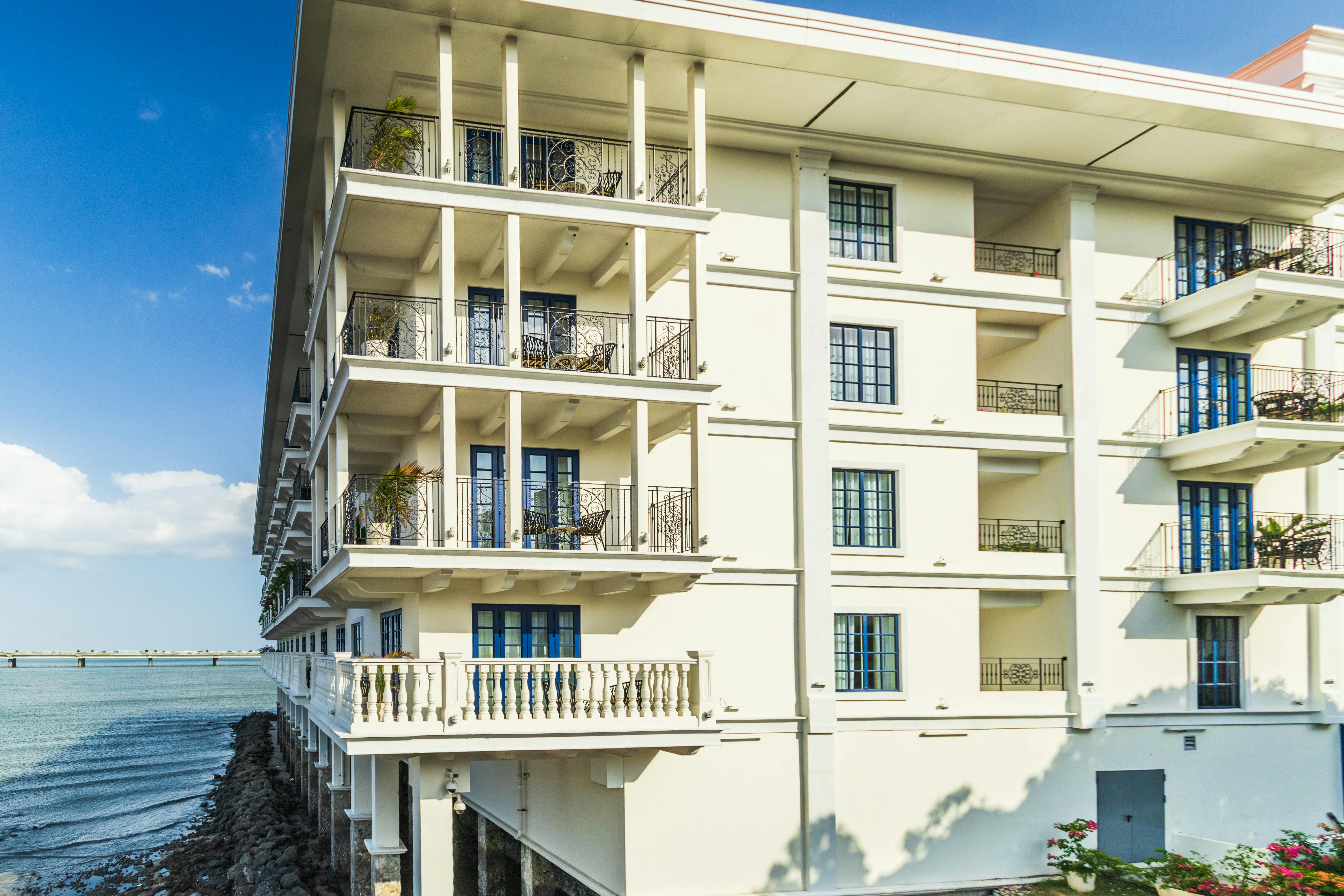 Stunning colonial style building with balconies overlooking the ocean in Panama City.