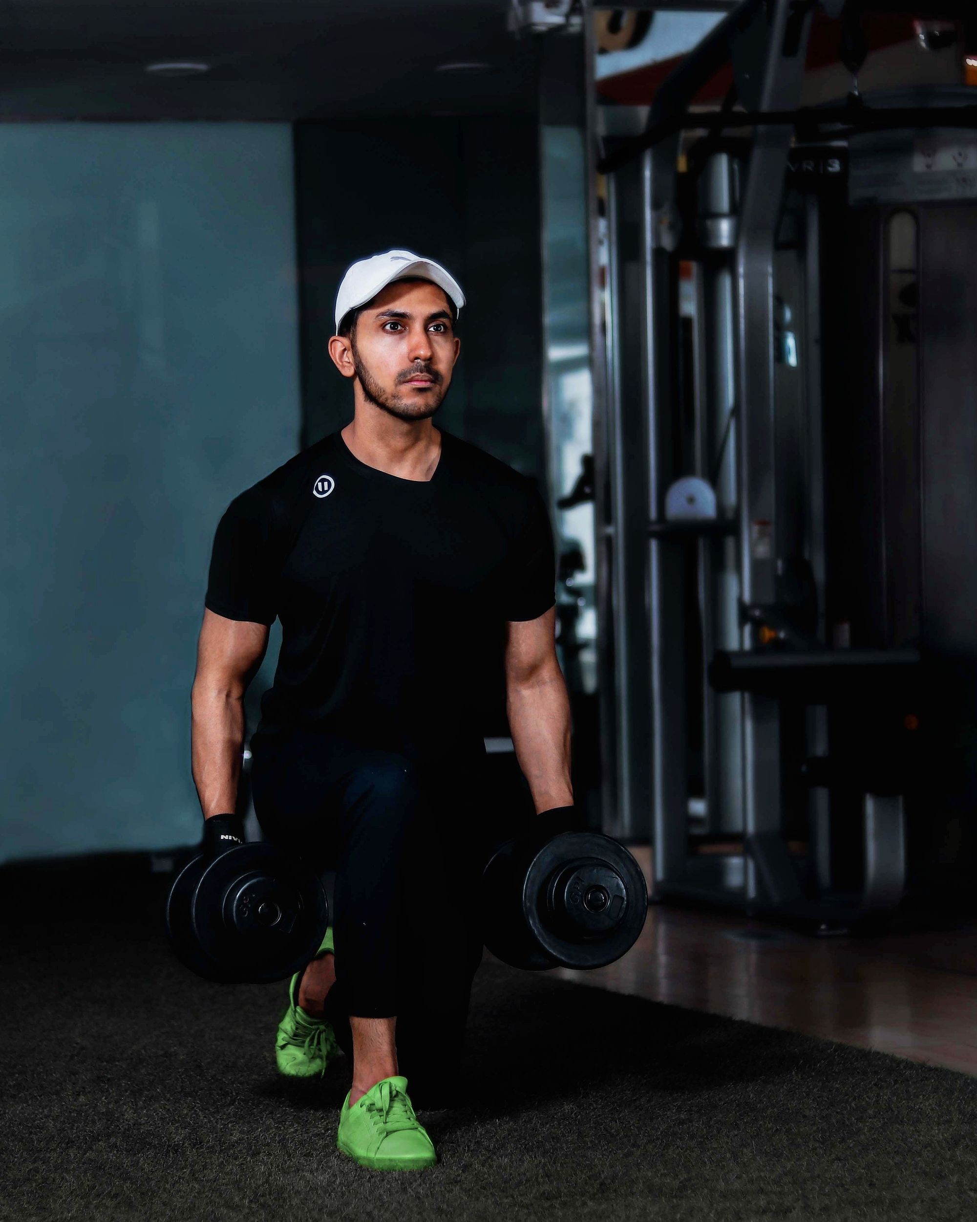 Athlete performing dumbbell strength training in a real gym environment