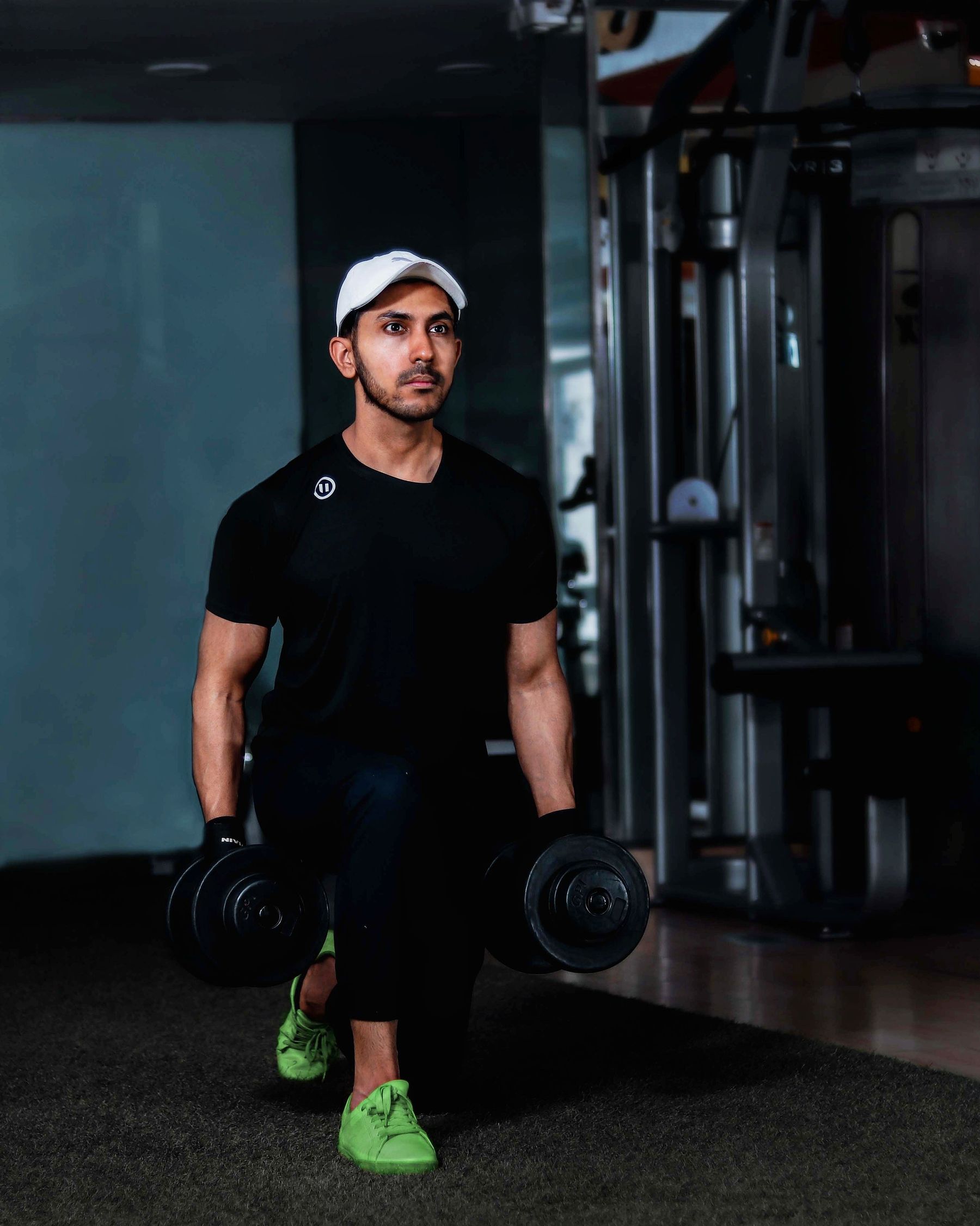 Athlete training with dumbbells in a real fitness environment