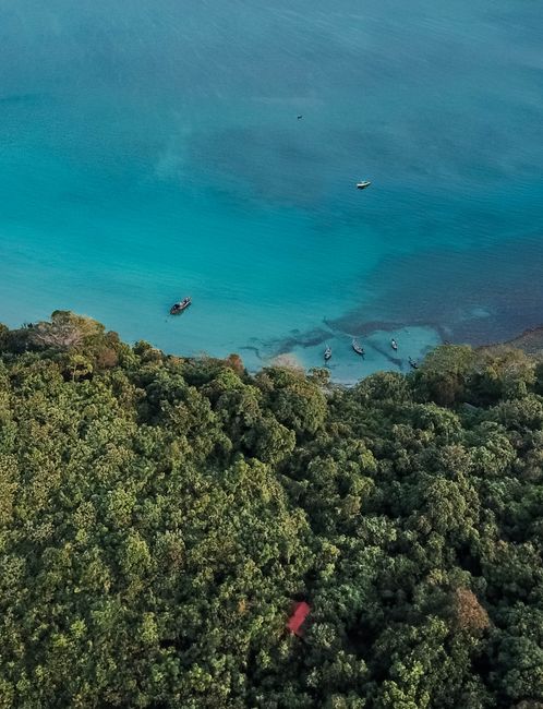 Aerial shot capturing the turquoise waters and lush forests of Launglon, Myanmar.