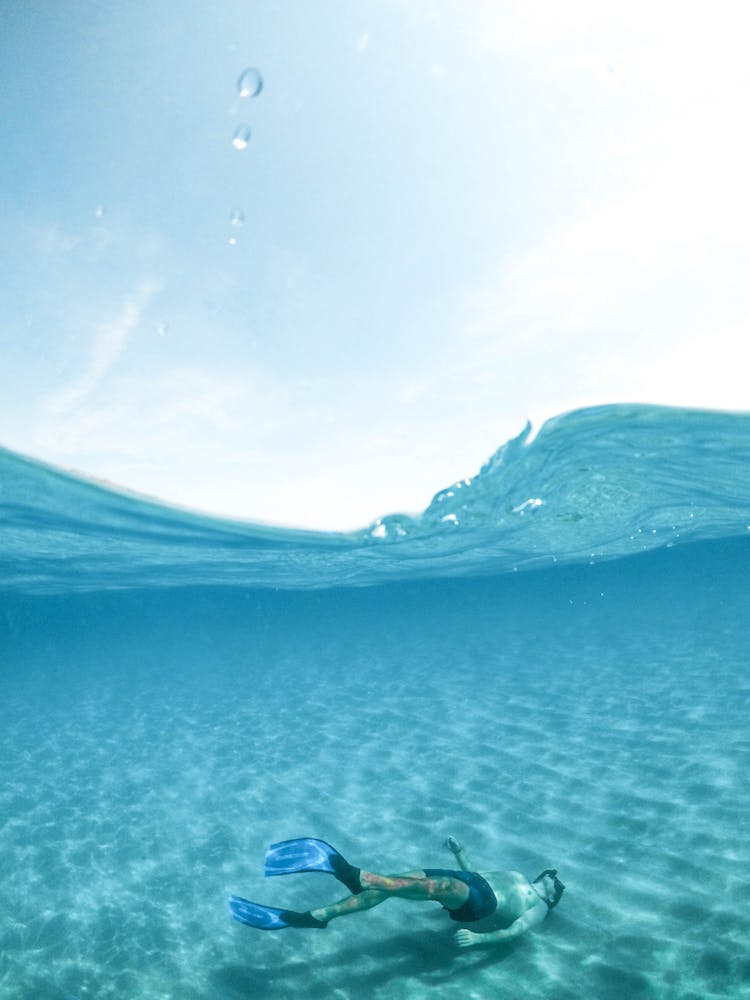 Man Diving On Body Of Water