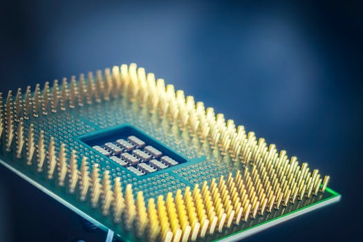 High-resolution macro shot of a computer CPU chip with gold pins against a blue background.