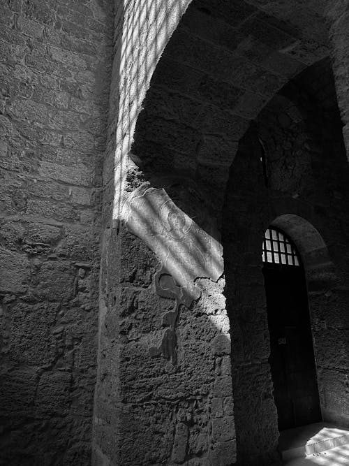 Black and white photograph of an archway in a castle