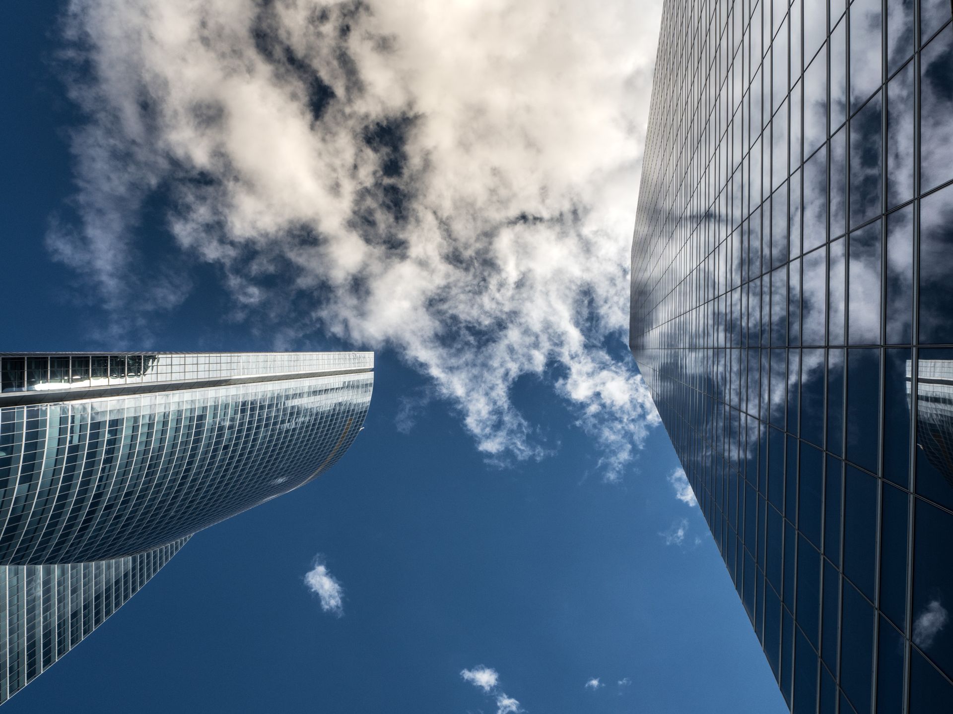 Worm's Eye View of High Rise Building Under White Cloudy Sky