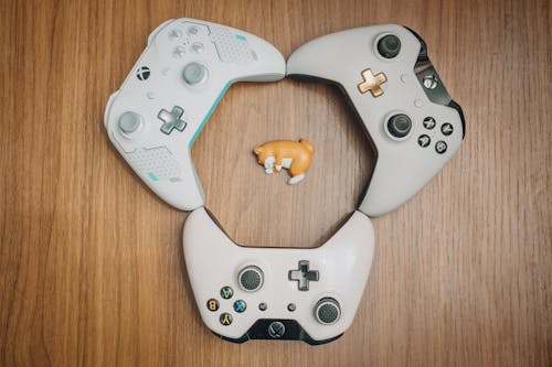 Three Gray and White Xbox Controller
