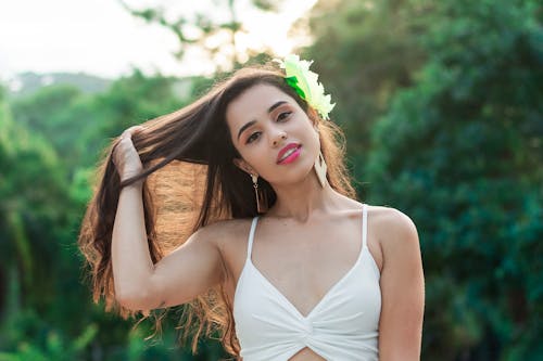 Free Photo of Woman in White Top Running Her Fingers Through Her Hair Stock Photo
