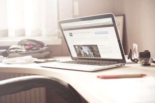 Black and Gray Laptop with Professional Website on a desk