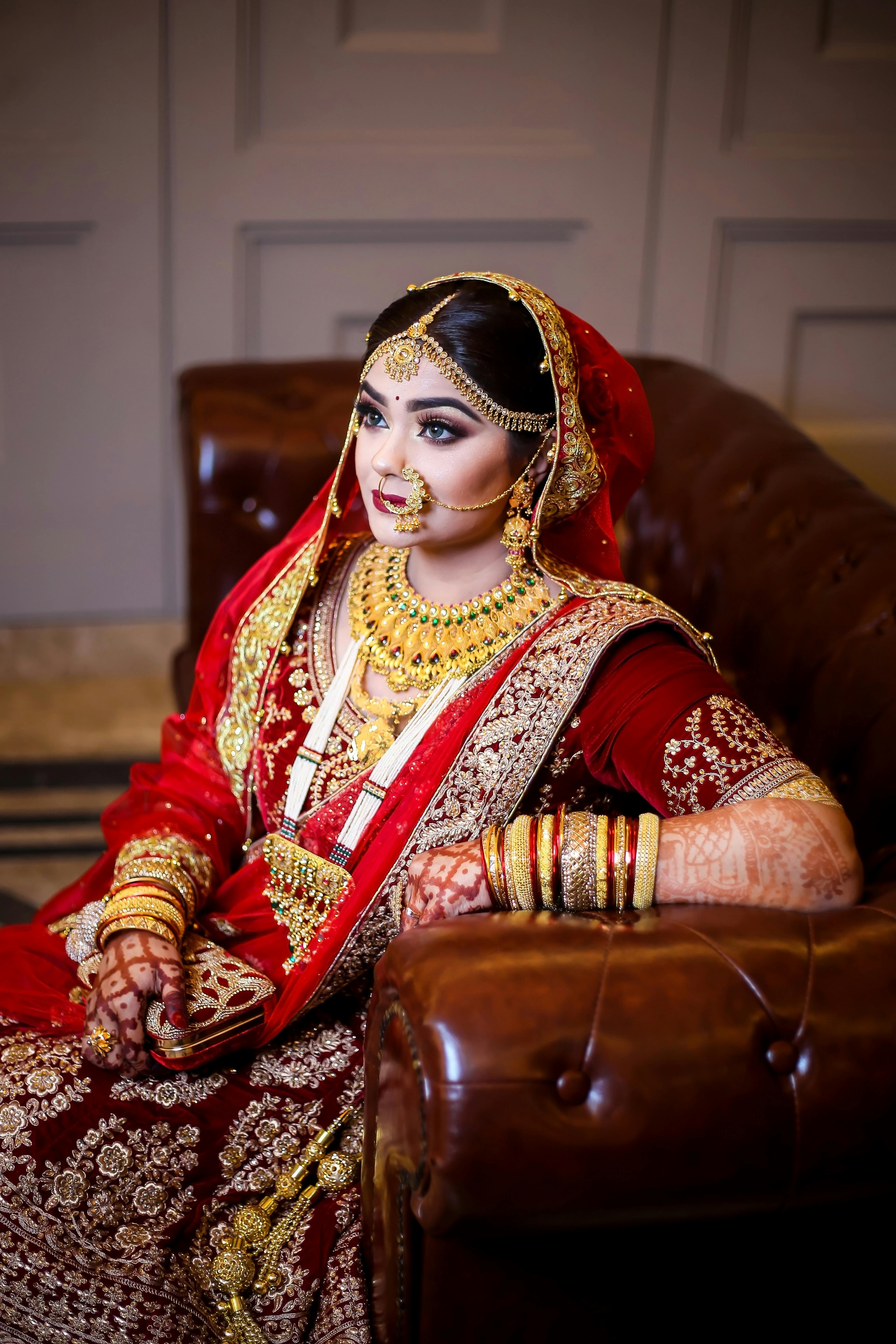 woman in red sari dress siting on sofa