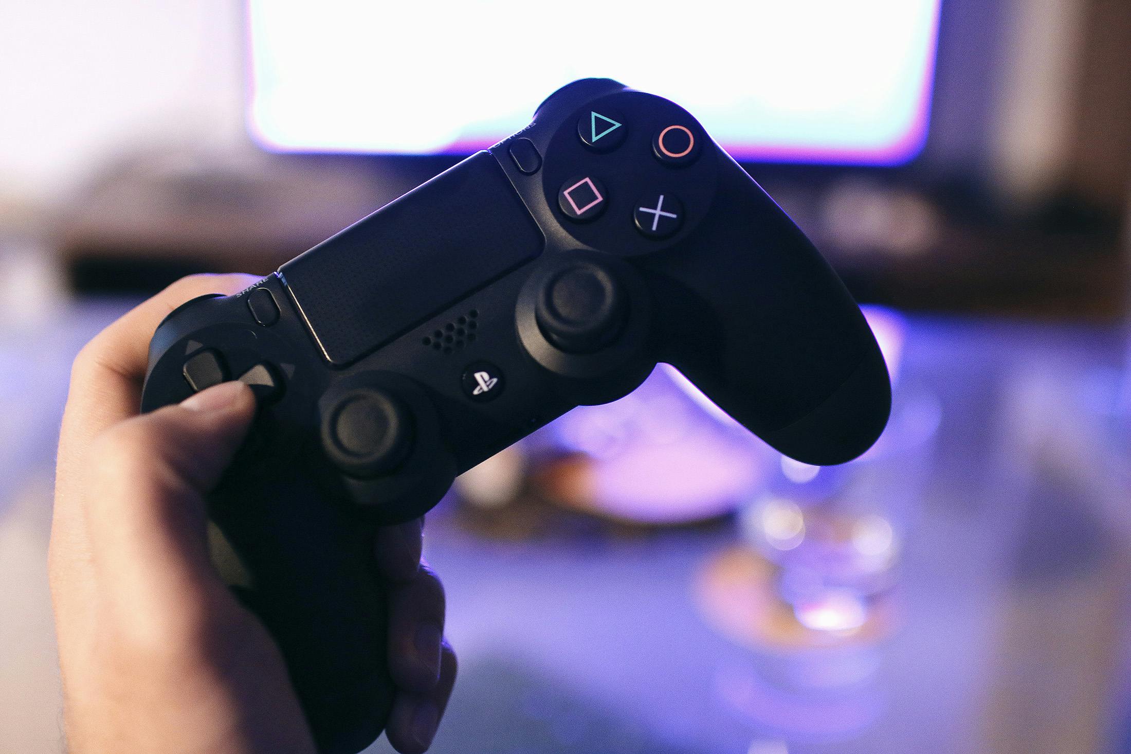 holding a ps4 controller