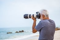 Man Taking Photo of Sea