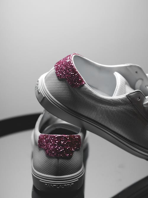 Free A pair of white sneakers with pink glitter on them Stock Photo