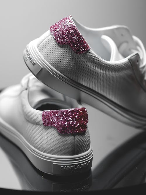 Free A pair of white sneakers with pink glitter on them Stock Photo