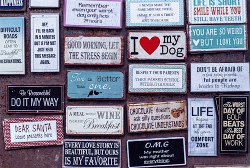 A bunch of different signs on a wall