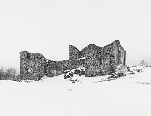 Black and white photo of an old castle in the snow