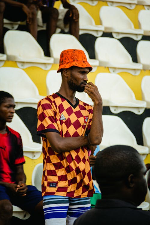 A man in a checkered shirt and hat