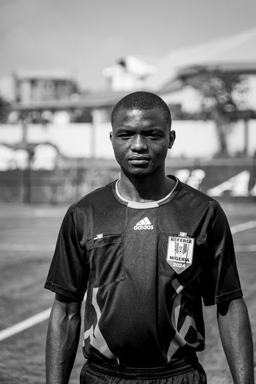 A black and white photo of a soccer player
