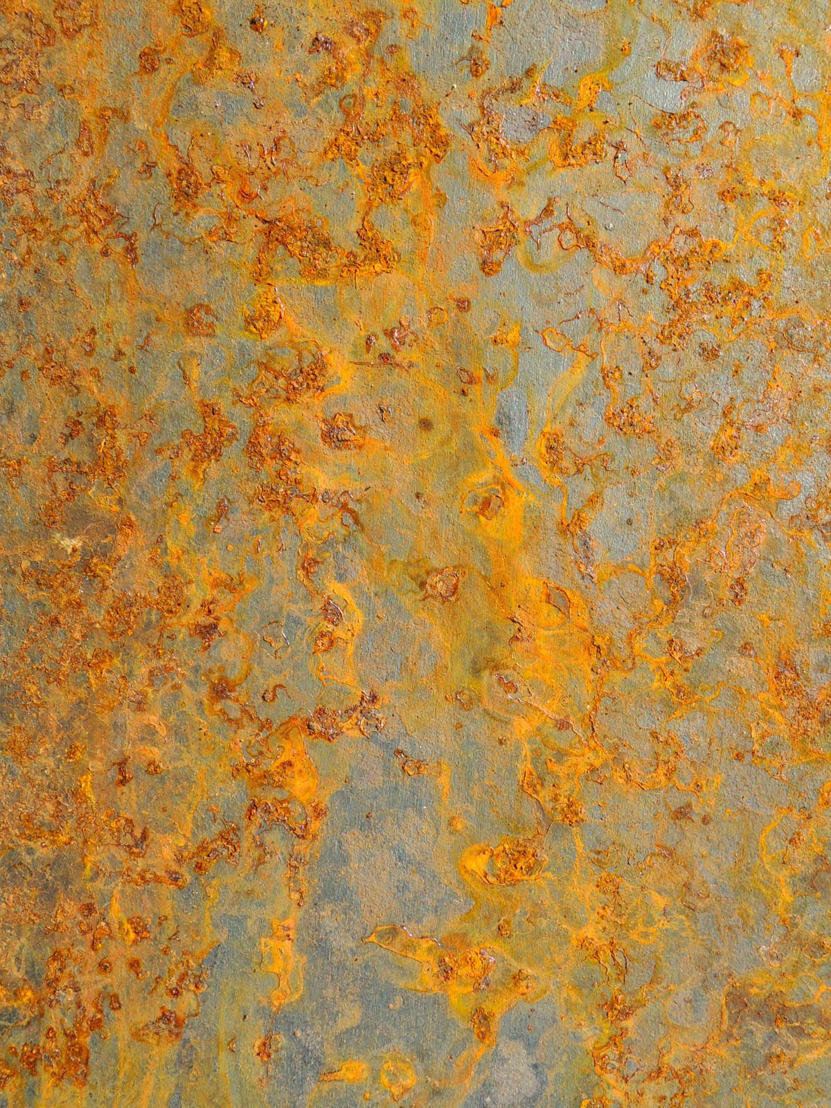 Close-up of a heavily rusted steel surface with orange and brown corrosion
