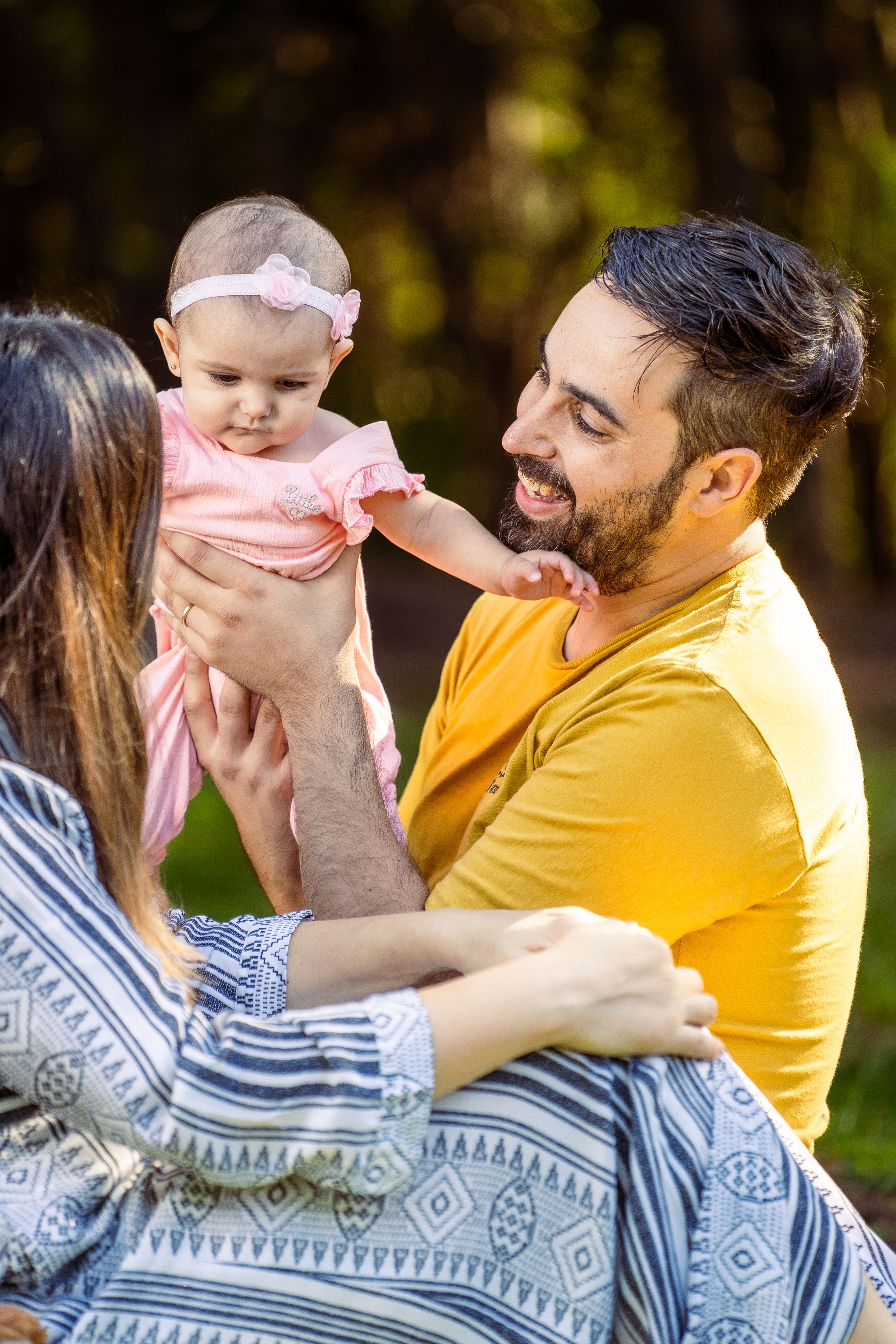 Parents enjoying time outside with their baby daughter