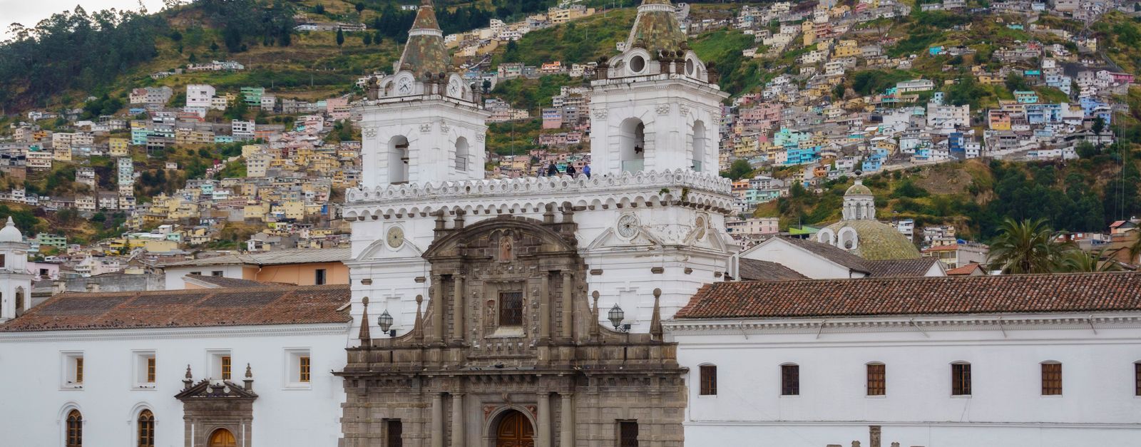 View of the historic San Francisco Church with sprawling hillside community in Quito, Ecuador.