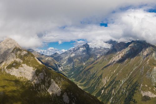Free Breathtaking aerial view of the Kals am Großglockner mountains in Tyrol, Austria with clouds and valleys. Stock Photo