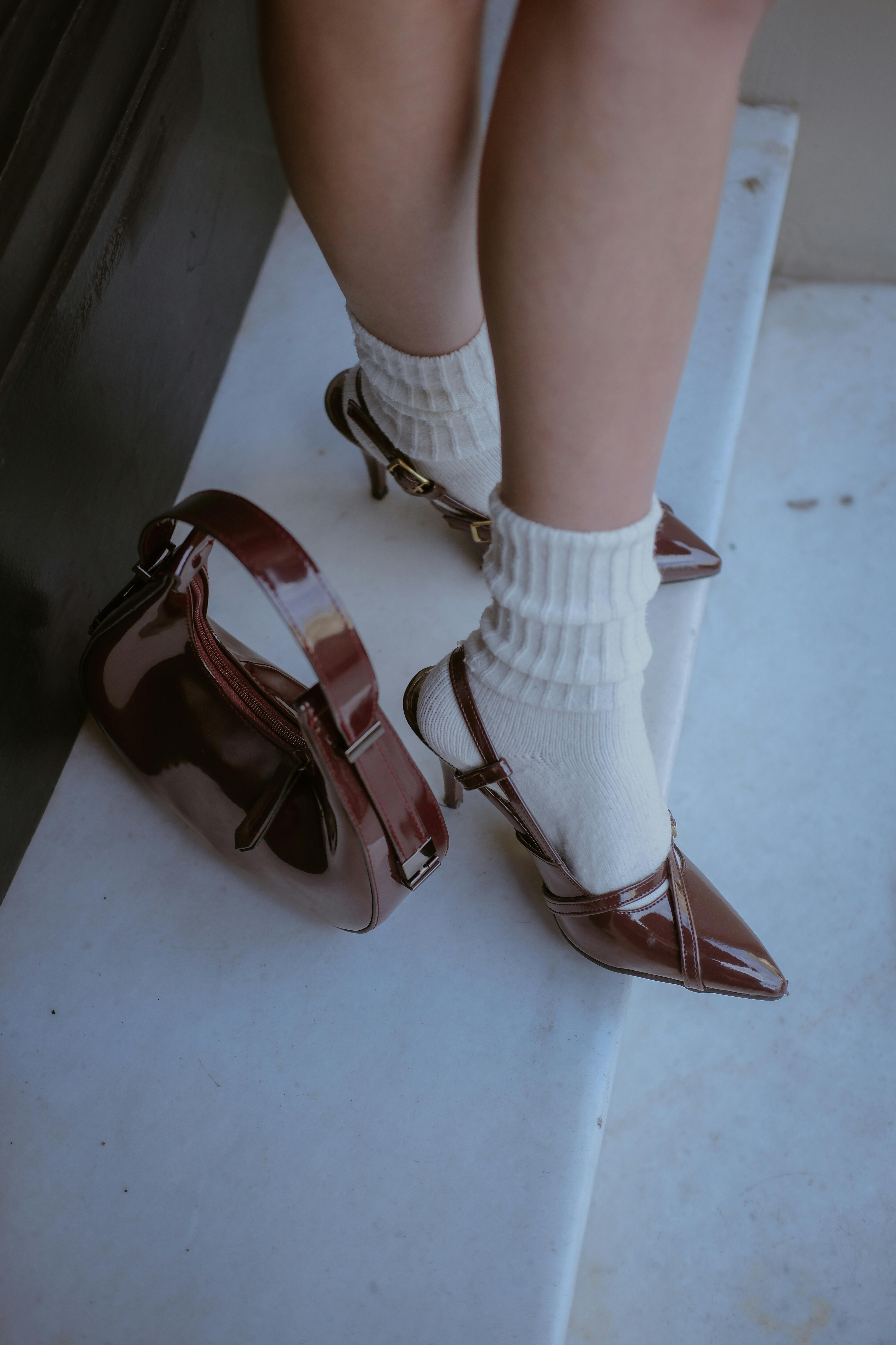 a woman s legs and feet wearing white socks and shoes