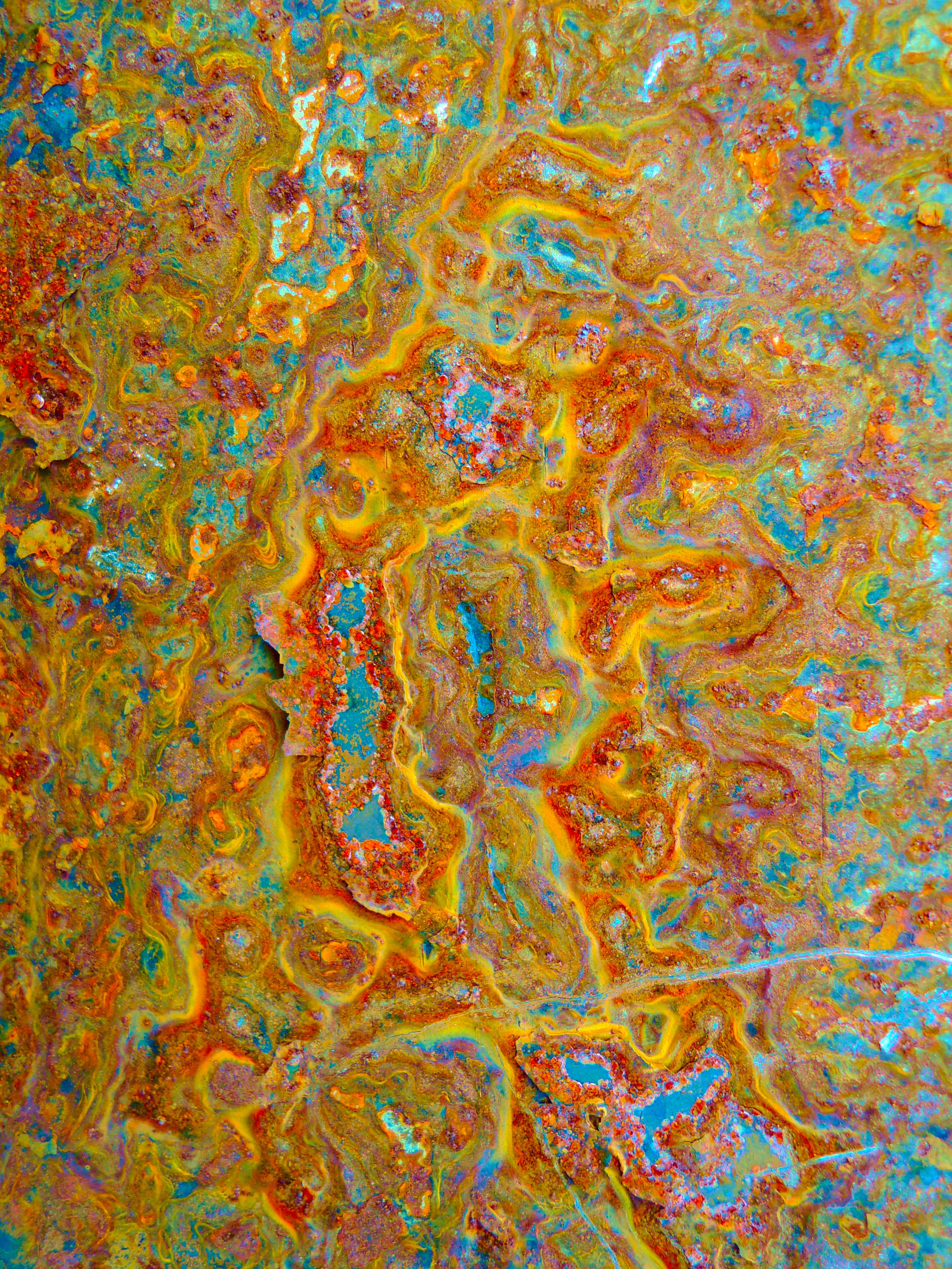 Colorful abstract texture resembling psychedelic artwork with vivid swirls and patterns.