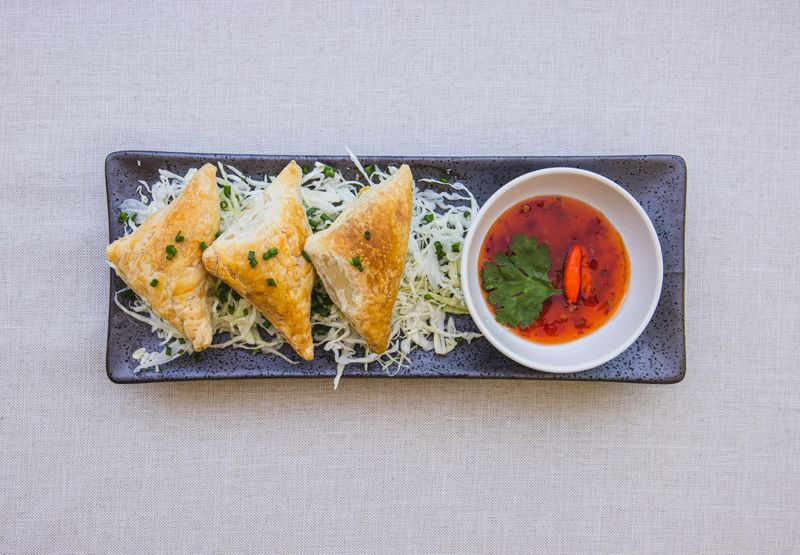 Crispy samosa served with red sauce