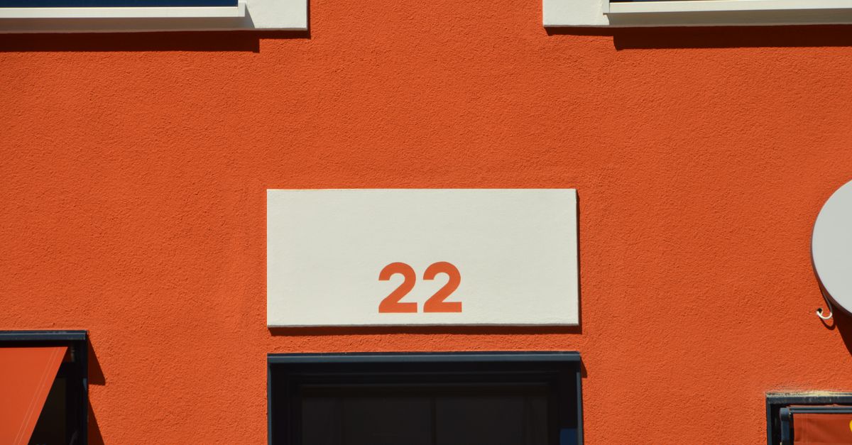 Vibrant orange building exterior with large number 22, modern design.