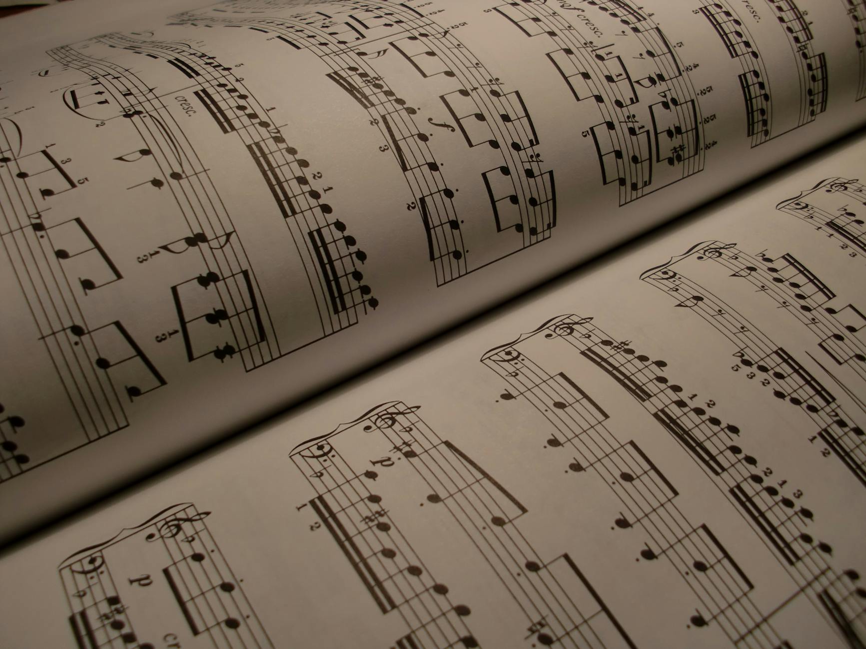 Detailed view of an open music book displaying musical notes and sheet music.