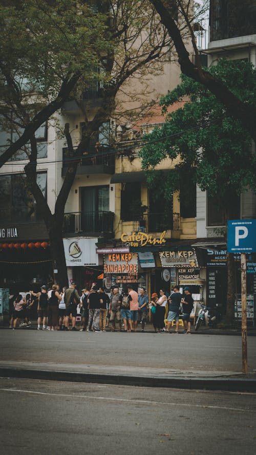 A group of people standing in front of a street