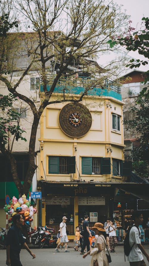 A clock tower in the middle of a city street