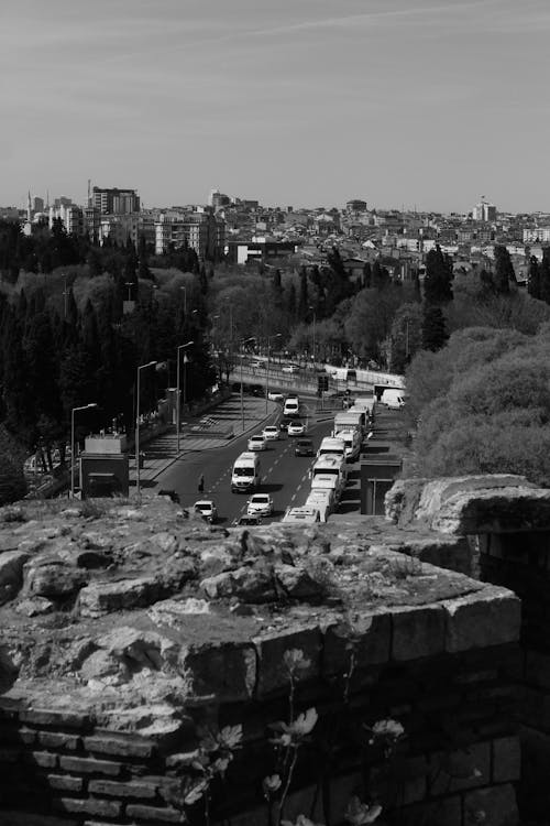 A black and white photo of a city with cars