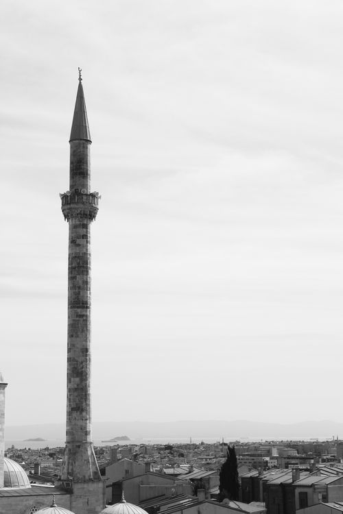 Free Monochrome photograph of cityscape featuring a tall minaret. Stock Photo