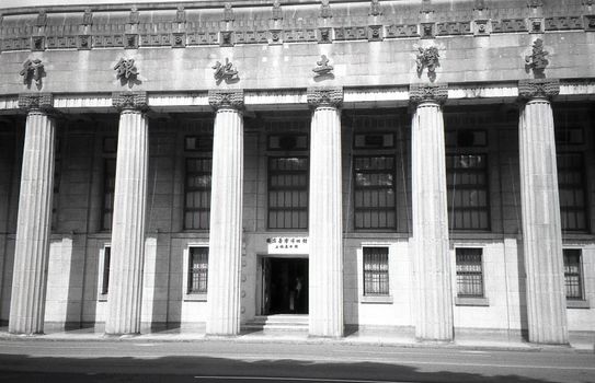 Monochrome view of the Taiwan Land Bank in Taipei showcasing neoclassical architecture.