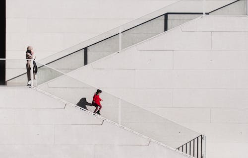 A woman and child are walking down a set of stairs