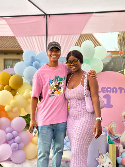 Free A Man and Woman Posing among Decorations at a First Birthday Party Stock Photo