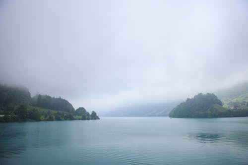 Free View of a Body of Water under Dense Clouds Stock Photo