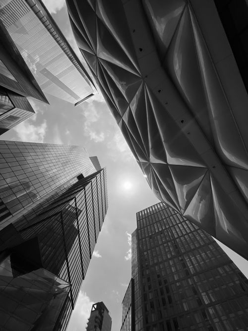 Free Dramatic low-angle view of modern skyscrapers in a cityscape, featuring geometric designs. Stock Photo