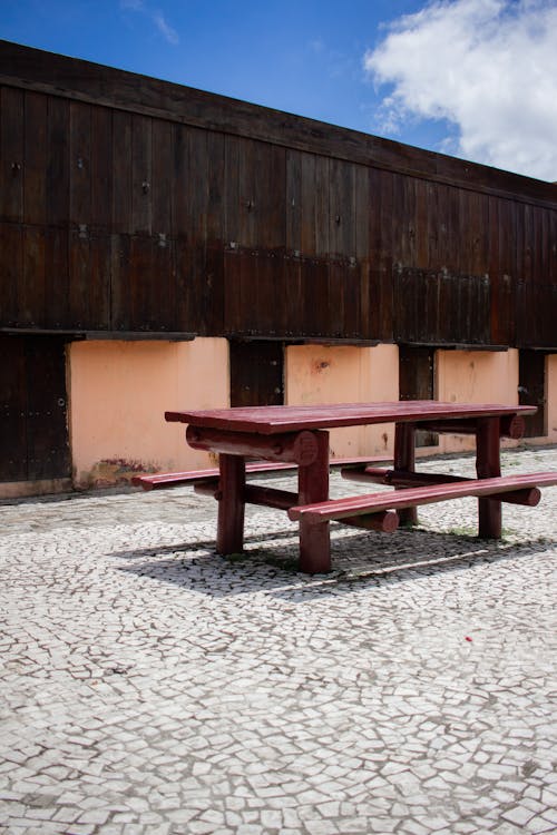 Brown Wooden Bench Near Brown Wooden Wall