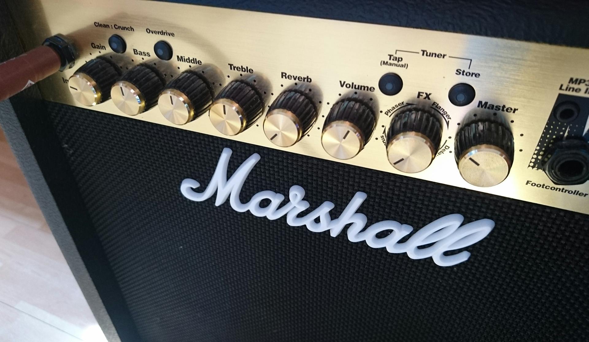 Detailed view of a Marshall amplifier's control panel with various knobs and switches.