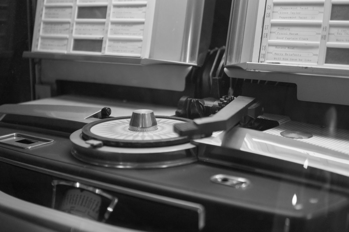 Black and white close-up of a classic vintage jukebox turntable mechanism