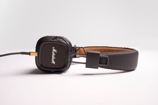 Stylish black over-ear headphones featuring a cushioned headband and branded earcups on a white background.