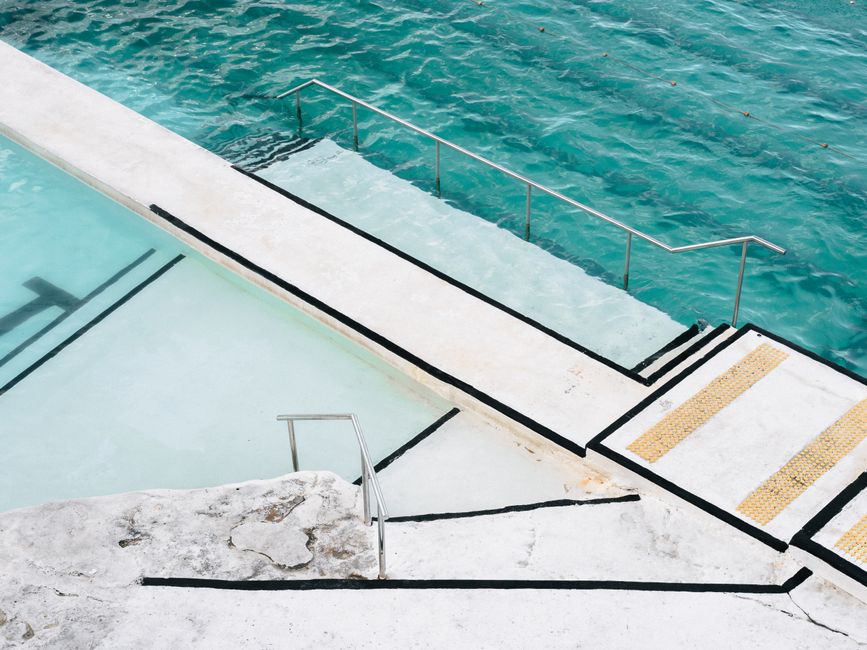 Stunning aerial shot of Bondi Icebergs pool blending with the turquoise ocean water.