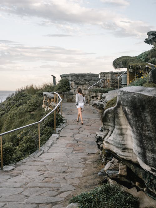 Woman Walking on Pathway