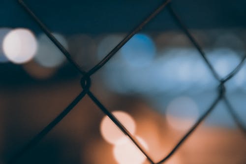 Shallow Focus Photography of Cyclone Fence